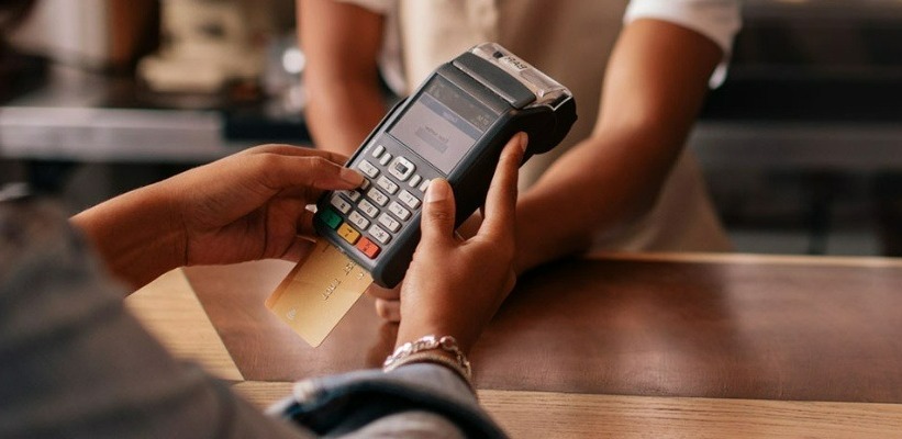 a person paying with a debit/credit card