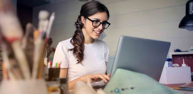 a young artist looking at her laptop