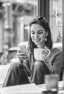 Lady using a smartphone in a coffee shop