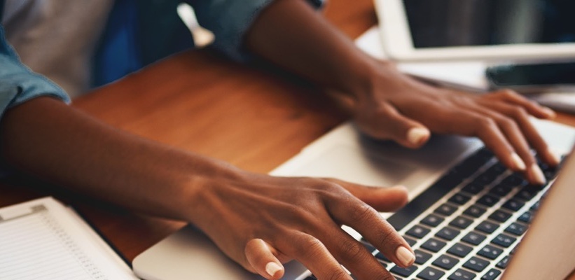 hands typing on a keyboard