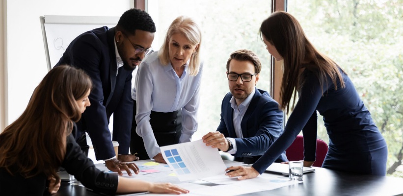 a group of employees in a meeting