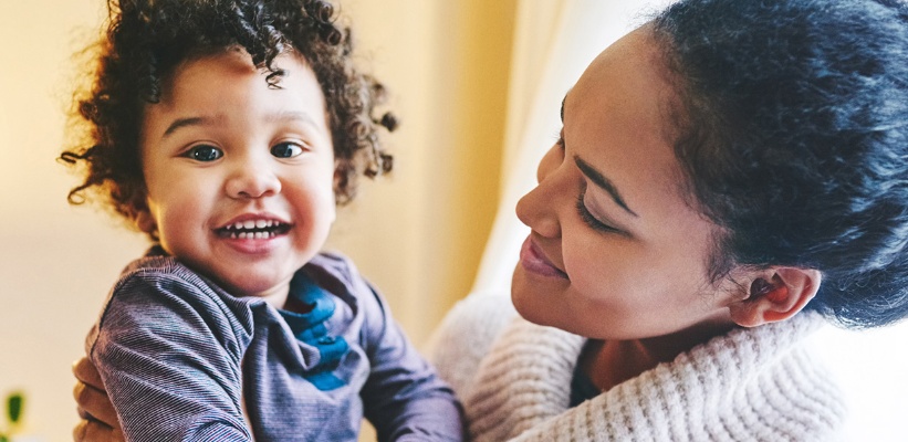 a child smiling with their mother